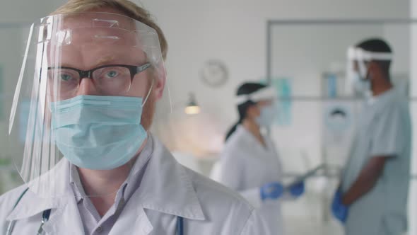 Portrait of Doctor in Protective Face Shield and Mask