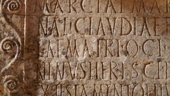 Carved words in stone panel at ancient Roman ruins at the archaelogical UNESCO Heritage site of Volu