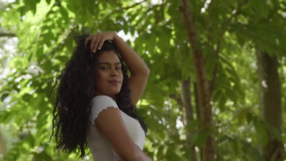 Amazing low angle view of a curly hair model in a park setting on a sunny day