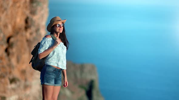 Adorable Touristic Stylish Female with Backpack Standing on Top of Mountain Relaxing Enjoying Nature