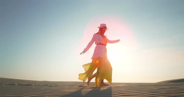 Cheerful Woman Dancing in Desert