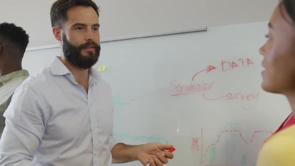 Diverse male and female business colleagues brainstorming at meeting in office