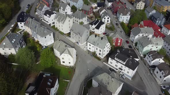 Top down view over Bergen Laksevaag and Damsgaard neighborhood - tilting up to reveal city with fjor