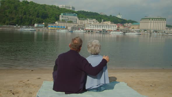 Lovely Mature Couple Relaxing at River Hugging in Carefree Place