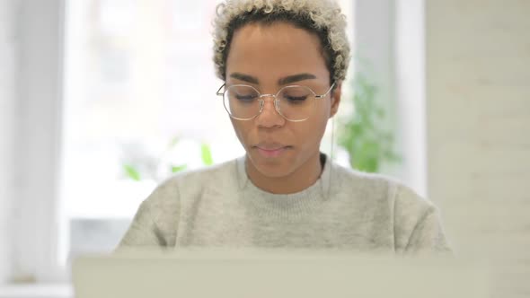 Close Up of African Woman with Laptop Showing Thumbs Down