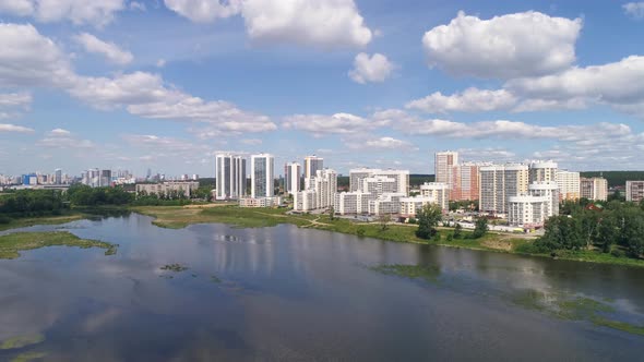 Aerial view of Modern multi-storey houses on the river bank in the city. 03