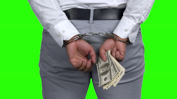Arrested Man in Handcuffs Holding Money