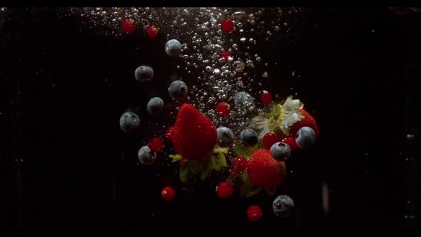 Falling Berries Into Water on a Black Background