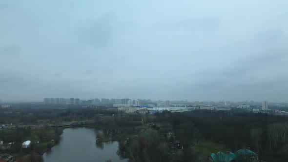 The river among the city park. Late autumn, cloudy.