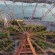 Drone View Colorful Ferris Wheel in Amusement Park on River and City Landscape - VideoHive Item for Sale