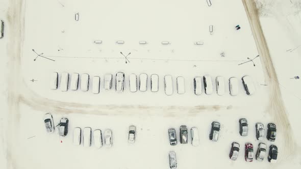 Many Cars in the Parking Lot After a Blizzard are Covered with Snow