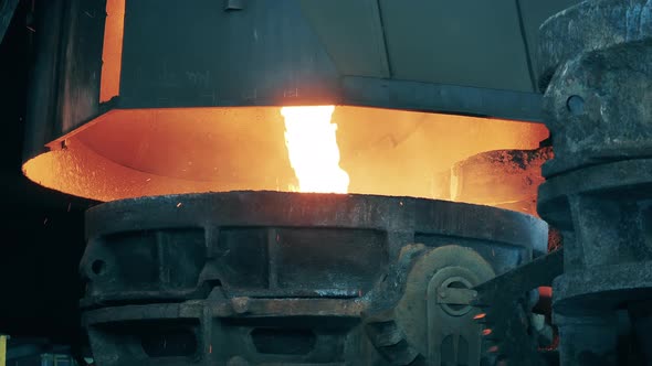 Molten Metal is Pouring Into a Massive Container