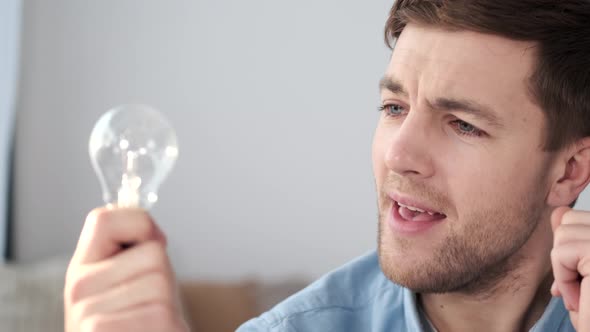 Man Found Excellent Idea Striked with Good Plan Raise Index Finger in Eureka Lightbulb Gesture