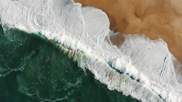 Aerial View of Powerful Ocean with Waves Washing Amber Beach