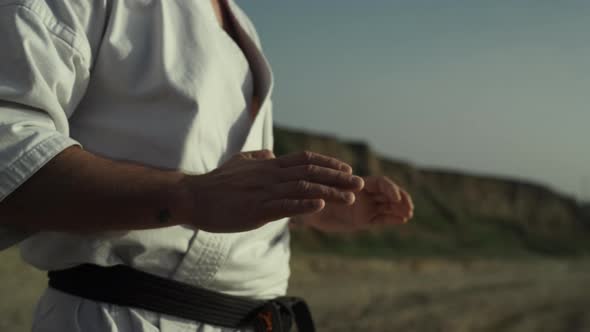 Hands Martial Arts Master Making Warmup Standing Beach at Sunset Close Up