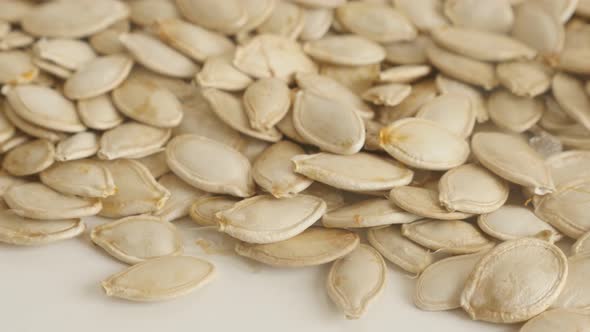 Pile of organic pepitas  close-up slow tilt 4K 2160p 30fps UltraHD footage - Unpeeled pumpkin seed 3