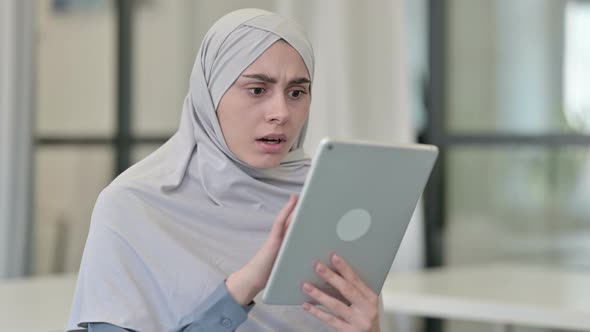 Young Arab Woman Reacting to Loss on Tablet