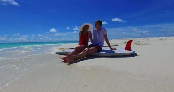 Young people in love dating on vacation live the dream on beach on white sand background 
