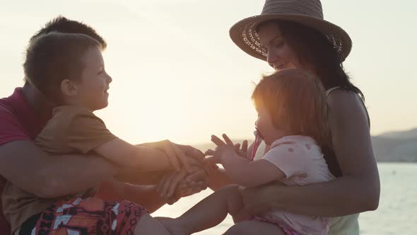 Amusing Video of a Family Team Together at Sunset By the Sea