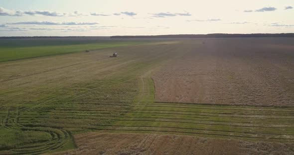 Aerial Landscape with Agricultural Machines at Harvesting