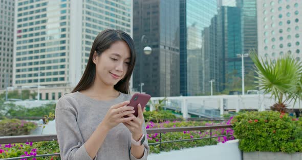 Woman use of smart phone in city