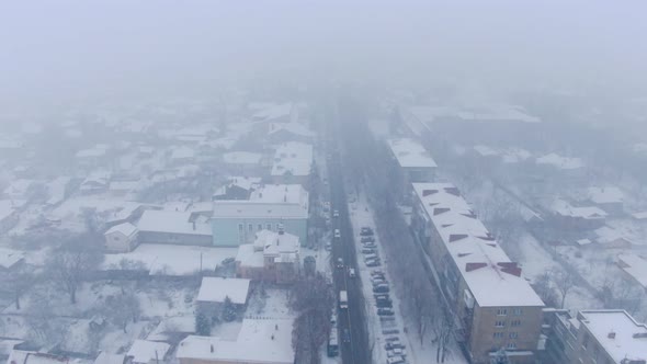 Aerial View of Small Town in Snowfall. Blizzard. Snowstorm.