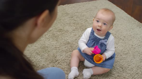 Baby Girl Interacting with her Mother