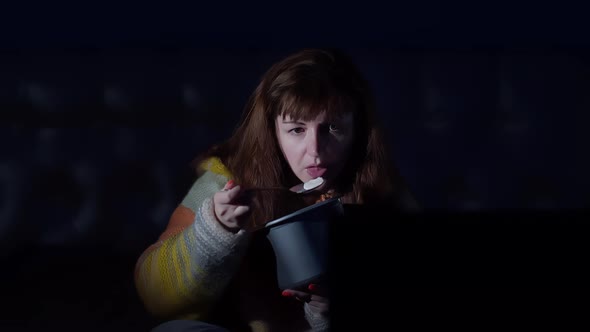 Woman Watching Tv at Night and Nervously Eating Ice Cream