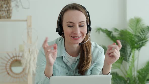 Brunette Woman Wears Headset Calling on Laptop Talks with Online Teacher Studying Working From Home