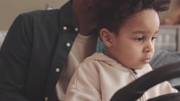 Little Boy Playing with Gaming Steering Wheel