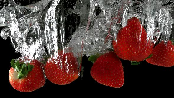 Slo-motion strawberry through water