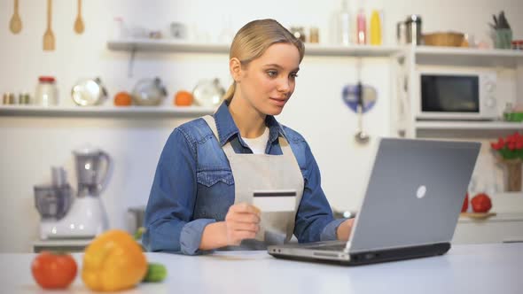 Beautiful Girl Paying for Food Purchase Over Internet, Convenient Online Service