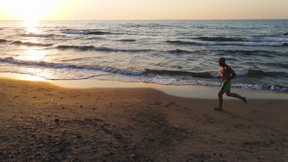 Slow motion shot of senior man jogging at beach