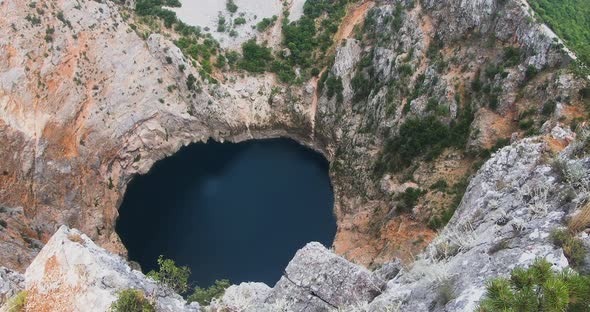 Wonderful karst Red Lake Crveno jezero in Croatia. Cliffs and Forest