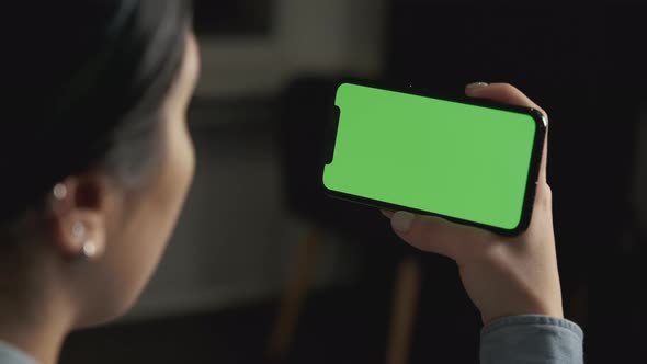 Close up Horizontal hands holding smartphone with green screen. Green screen mobile phone 