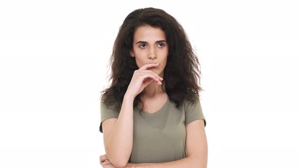 Portrait of Concentrated Brunette Woman Touching Chin Thinking About Important Things and Doubting