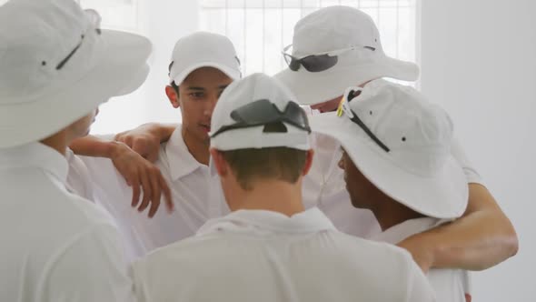 Cricket team motivating each other before playing