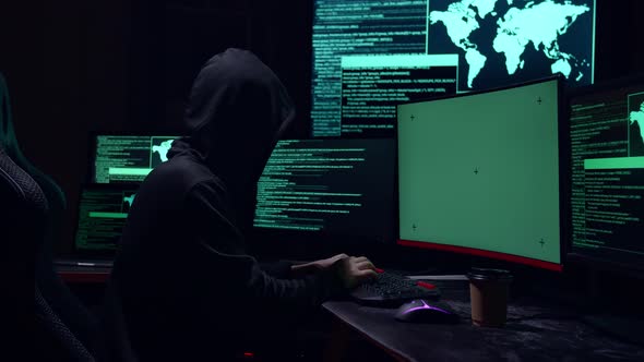 Hacker Hacking With Isolated Mock-Up Green Screen And Code On Multiple Computer Screens