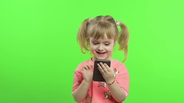 Little Girl Using Smartphone. Portrait of Child with Smartphone Texting, Playing