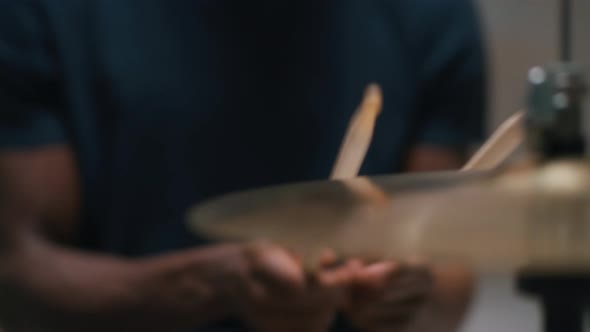 Crop Black Musician Playing Drums in Evening
