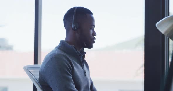 Man with headset working on computer