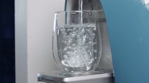 Slow motion of a water cup filling in a water filtering machine