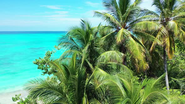 Wide angle fly over tourism shot of a summer white paradise sand beach and blue water background in 