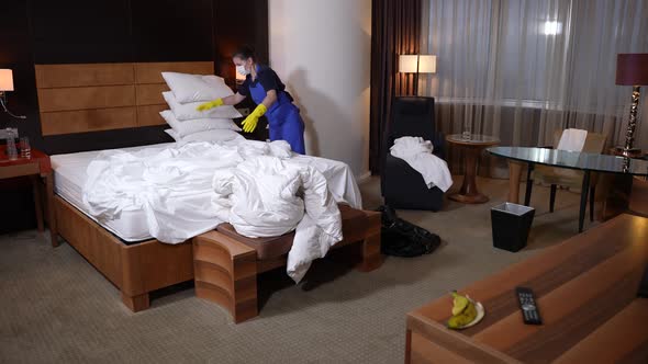 Maid Working in Hotel Room During Covid Epidemic