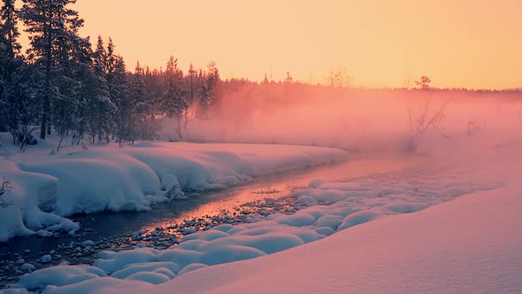 Evening Rose Mist over the Snow-Covered Forest and a River