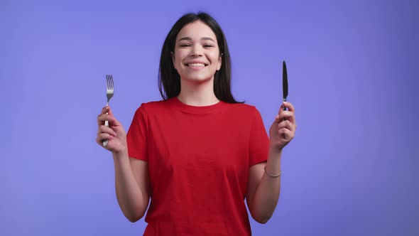 Portrait of Hungry Woman with Fork and Knife