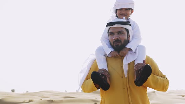 Father and son making a safari in the desert