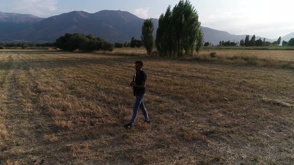 Man Playing Guitar In Countryside