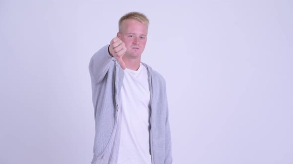 Angry Young Blonde Man Giving Thumbs Down