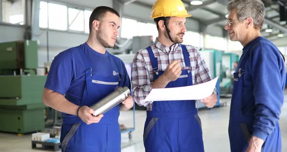 Engineer Teaching Apprentices To Use Computerized Cnc Metal Processing Machines